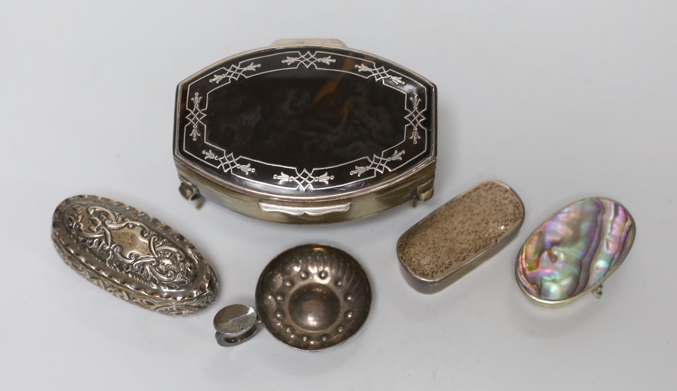 A George V silver and tortoiseshell mounted trinket box, Chester, 1915, 79cm, a late Victorian repousse box, a French taste vin and two later pill boxes.